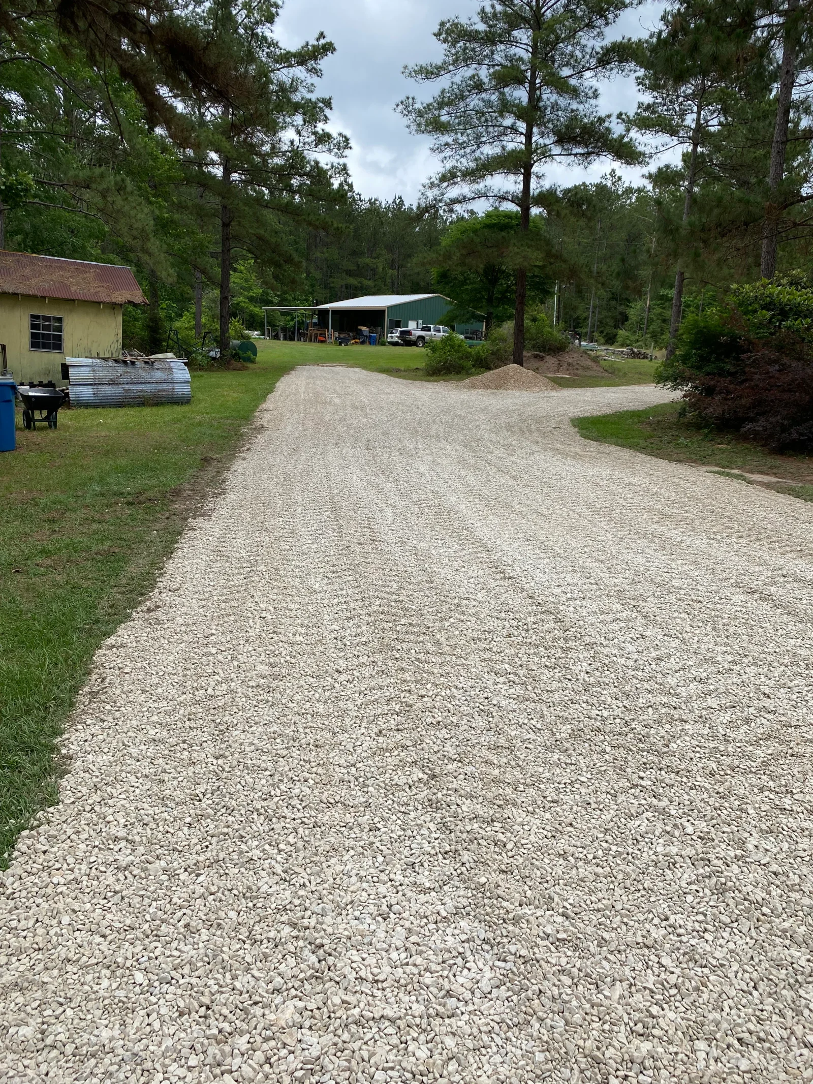 Newly installed crushed stone gravel driveway with clean edges and proper grading on residential property